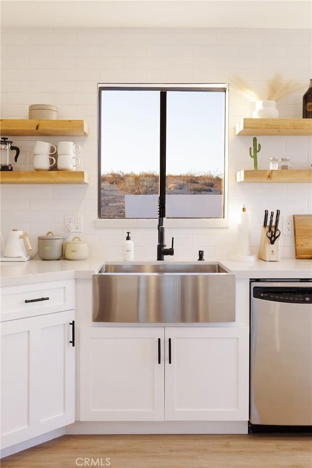 kitchen featuring dishwasher, open shelves, light countertops, and white cabinetry