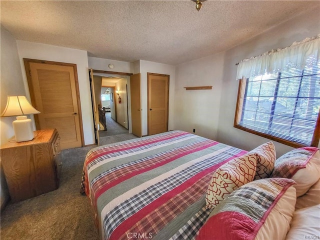 carpeted bedroom featuring a textured ceiling