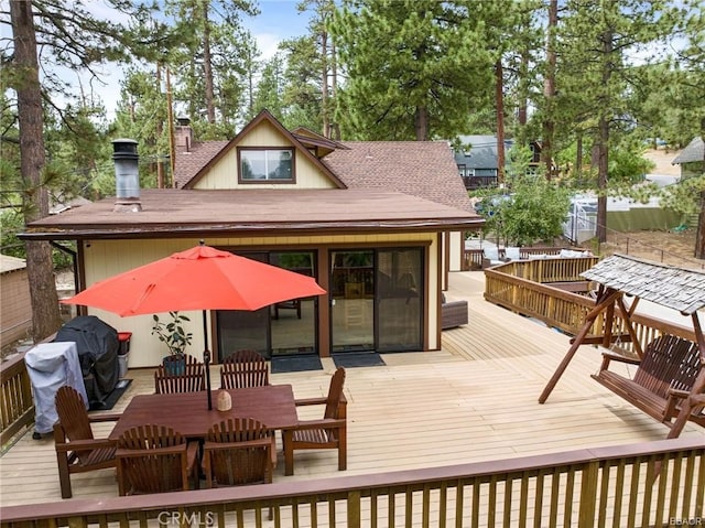 wooden deck featuring a grill