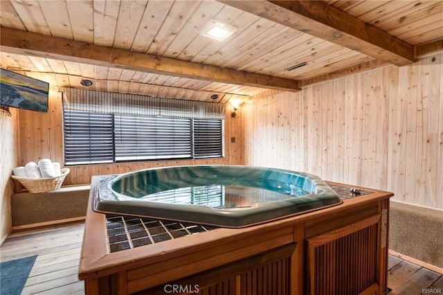 miscellaneous room with wooden walls and a hot tub