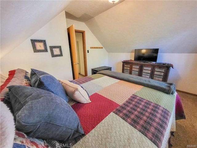 bedroom featuring carpet flooring, vaulted ceiling, and baseboards