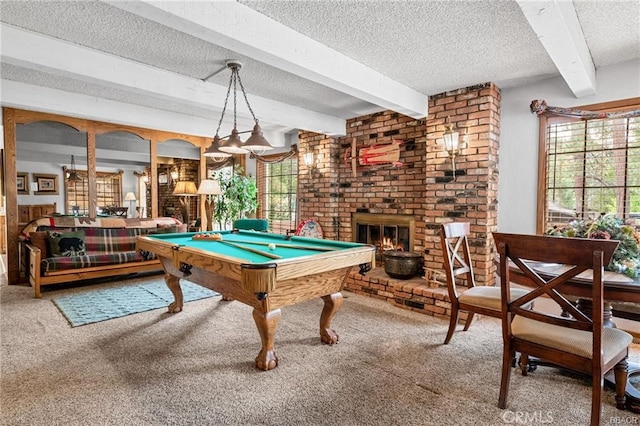 recreation room with carpet floors, a brick fireplace, beamed ceiling, and a textured ceiling