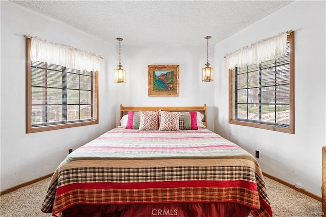 carpeted bedroom with baseboards and a textured ceiling