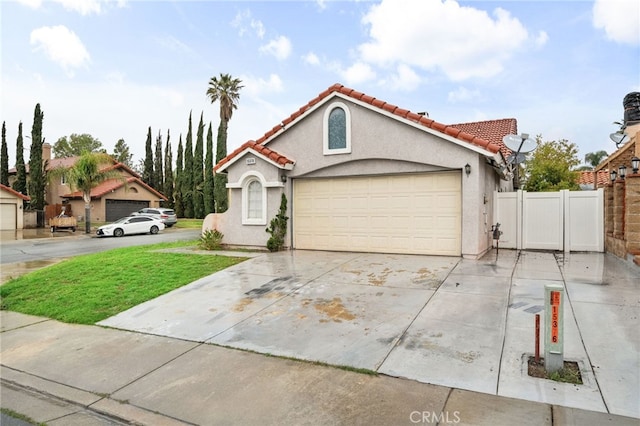 view of front facade with stucco siding, driveway, a tile roof, fence, and a garage