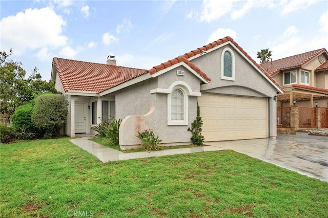 mediterranean / spanish-style home featuring a tiled roof, concrete driveway, a front yard, stucco siding, and a chimney