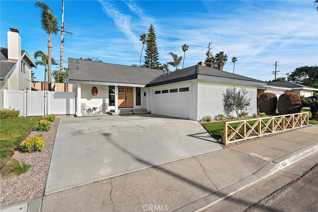 single story home featuring a garage, fence, concrete driveway, a gate, and stucco siding