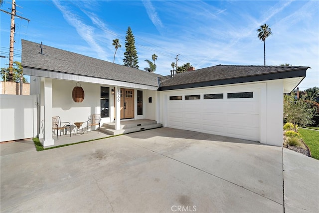 single story home with roof with shingles, stucco siding, an attached garage, fence, and driveway