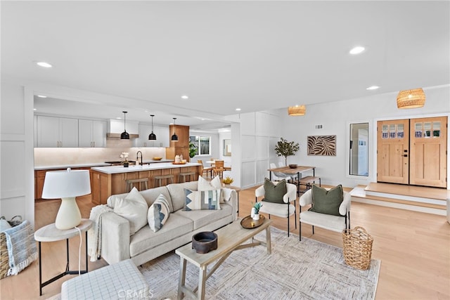 living area featuring light wood-type flooring and recessed lighting