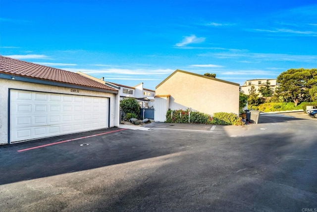 exterior space with community garages and stucco siding