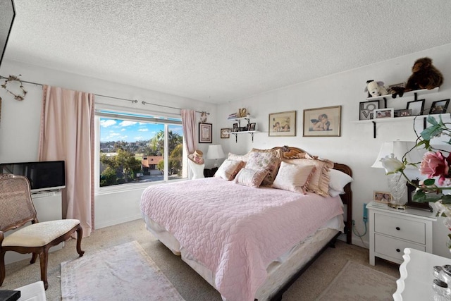 bedroom with a textured ceiling and light carpet