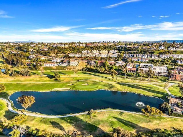 drone / aerial view featuring view of golf course and a water view