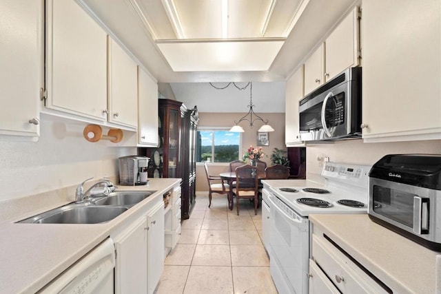 kitchen with light tile patterned floors, white appliances, a sink, white cabinetry, and light countertops