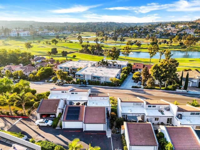 aerial view featuring a water view, view of golf course, and a residential view