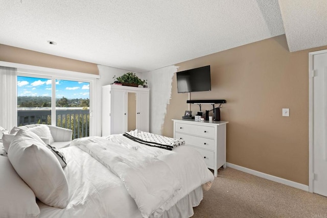 bedroom with baseboards, a textured ceiling, and light colored carpet