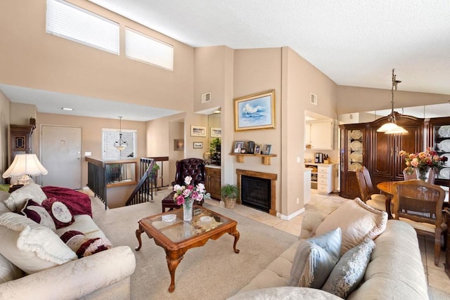 living room with lofted ceiling, visible vents, a fireplace, and light tile patterned floors