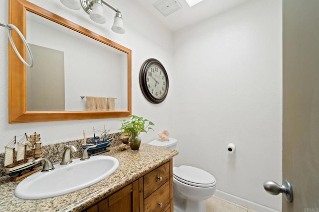 half bathroom with toilet, tile patterned floors, visible vents, and vanity