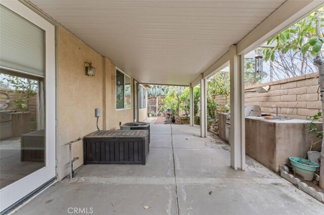 view of patio featuring fence