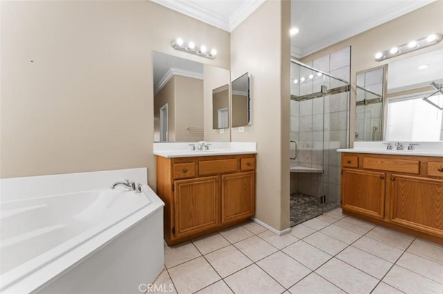 full bath featuring two vanities, a stall shower, tile patterned flooring, crown molding, and a bath