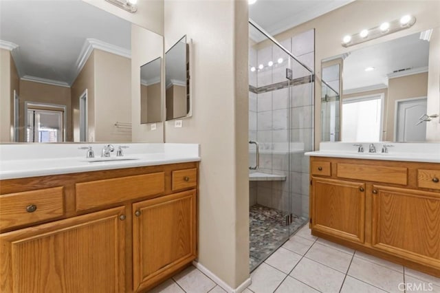 full bath featuring crown molding, tile patterned floors, a shower stall, and a sink