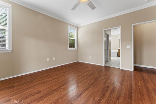 unfurnished bedroom with a ceiling fan, wood finished floors, connected bathroom, crown molding, and baseboards