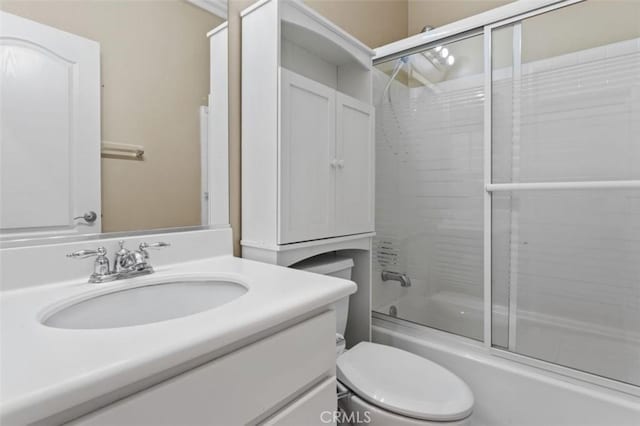 full bathroom with toilet, vanity, and shower / bath combination with glass door