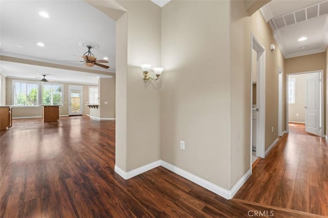 hallway featuring visible vents, baseboards, ornamental molding, recessed lighting, and dark wood-style floors