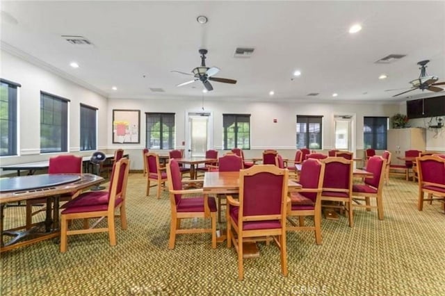 dining room featuring visible vents, light colored carpet, and ceiling fan