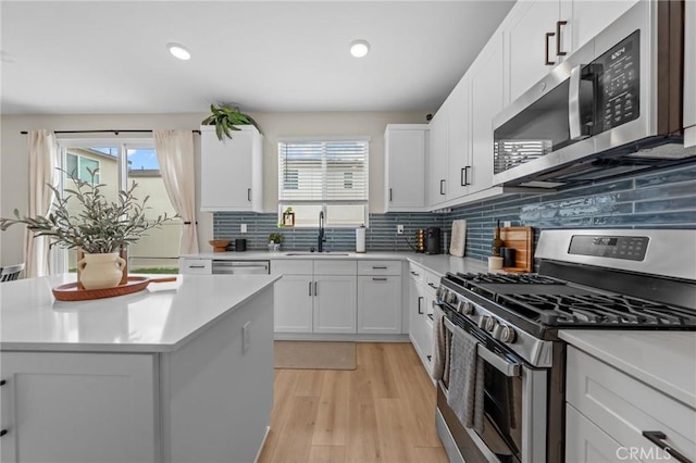 kitchen with a wealth of natural light, stainless steel appliances, a sink, and light countertops