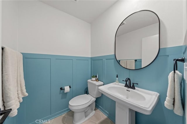 34720 Mustang Ln, Fallbrook, CA 92028 - half bathroom with wainscoting, a decorative wall, and tile patterned flooring