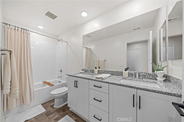 bathroom with toilet, visible vents, a sink, and shower / tub combo with curtain