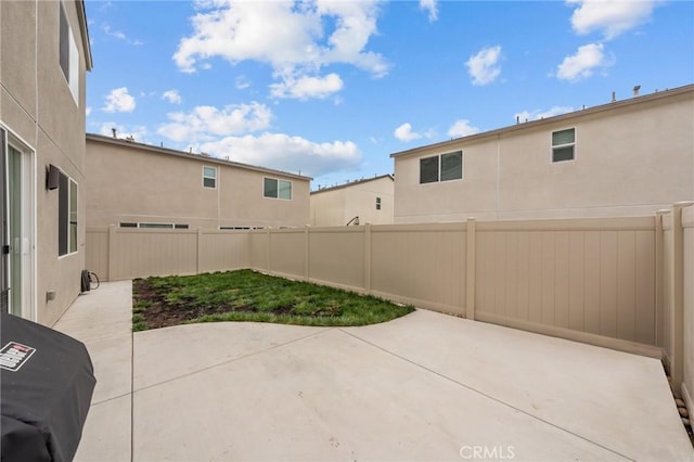 view of patio with a fenced backyard and a grill