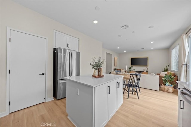 34720 Mustang Ln, Fallbrook, CA 92028 - kitchen with freestanding refrigerator, light wood finished floors, a kitchen island, white cabinetry, and recessed lighting