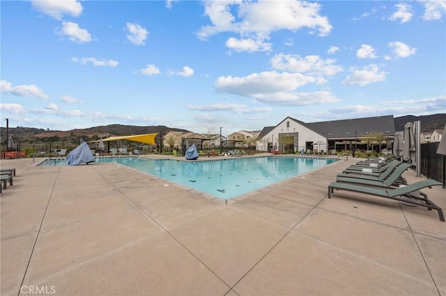 community pool featuring a patio area and fence