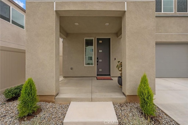 34720 Mustang Ln, Fallbrook, CA 92028 - view of exterior entry featuring stucco siding, a garage, and concrete driveway