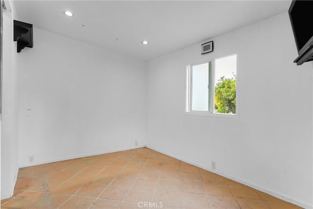 empty room featuring recessed lighting, baseboards, and light tile patterned floors