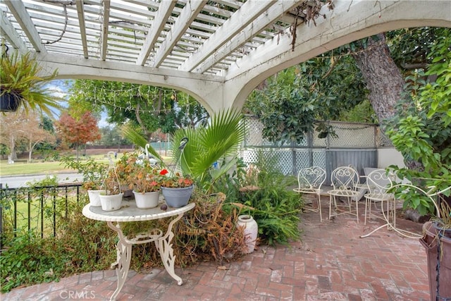 view of patio / terrace featuring outdoor dining area, fence, and a pergola