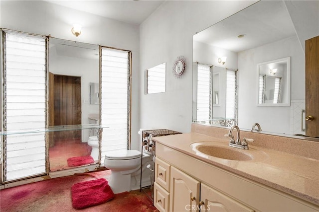 bathroom featuring toilet and vanity