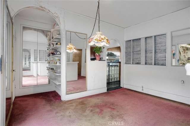 unfurnished dining area featuring carpet flooring