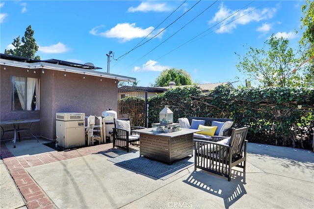 view of patio featuring an outdoor fire pit and fence