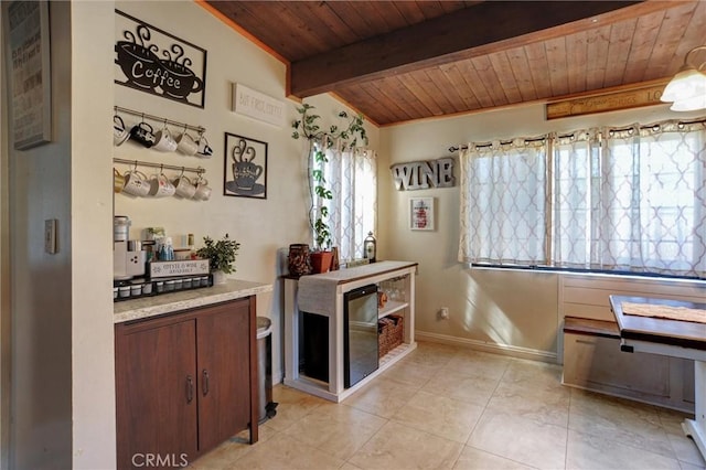 interior space with wooden ceiling, vaulted ceiling with beams, baseboards, and light tile patterned floors