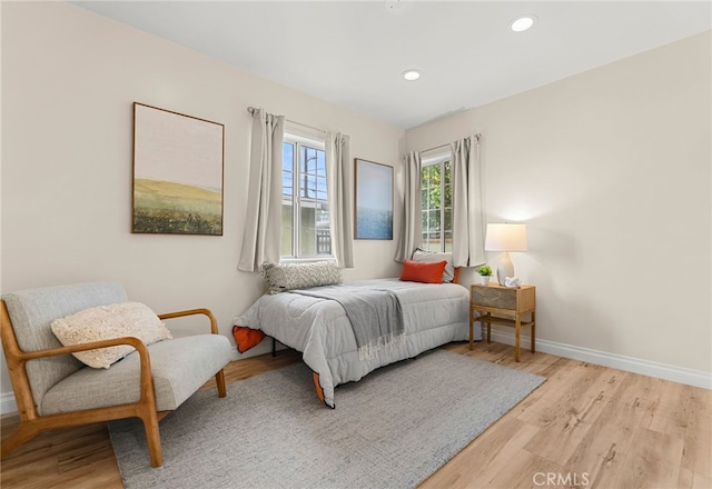 bedroom featuring light wood finished floors, baseboards, and recessed lighting