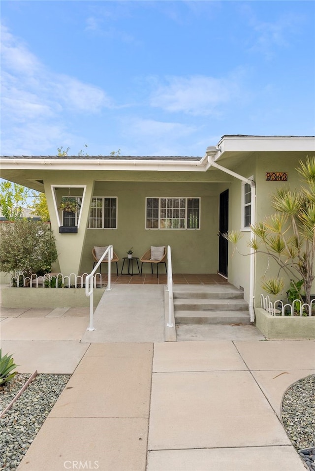 view of front of home featuring a patio area and stucco siding