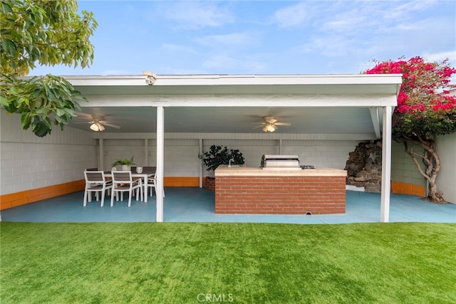 view of patio with ceiling fan, outdoor dry bar, and area for grilling