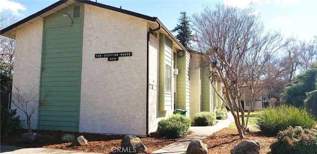 view of side of property with stucco siding