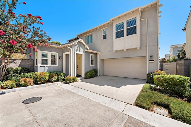 view of front of property featuring driveway, a garage, and stucco siding