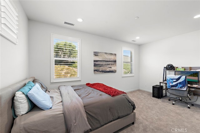 carpeted bedroom featuring recessed lighting, visible vents, and baseboards