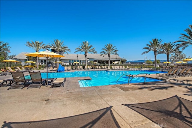 community pool featuring a patio area and fence