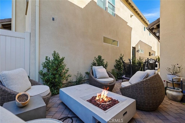 view of patio with a fire pit and fence