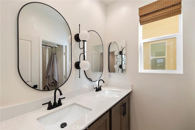 bathroom featuring a sink and double vanity