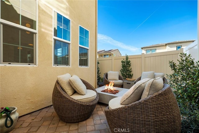 view of patio with a fire pit and fence